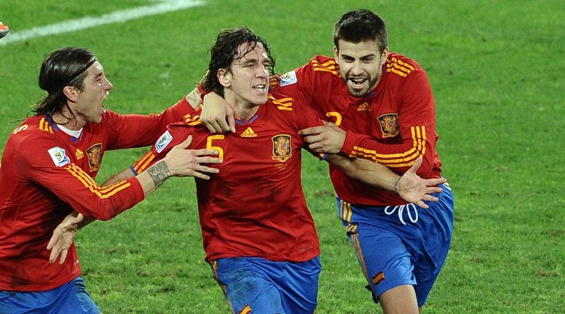 Sergio Ramos and Gerard Pique celebrate with Carles Puyol after his goal for Spain against Germany at the 2010 World Cup.