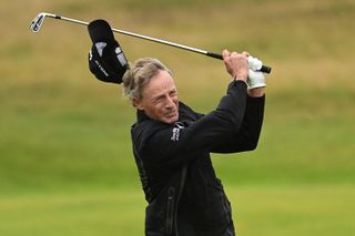 Bernhard Langer's cap falls off during a golf swing