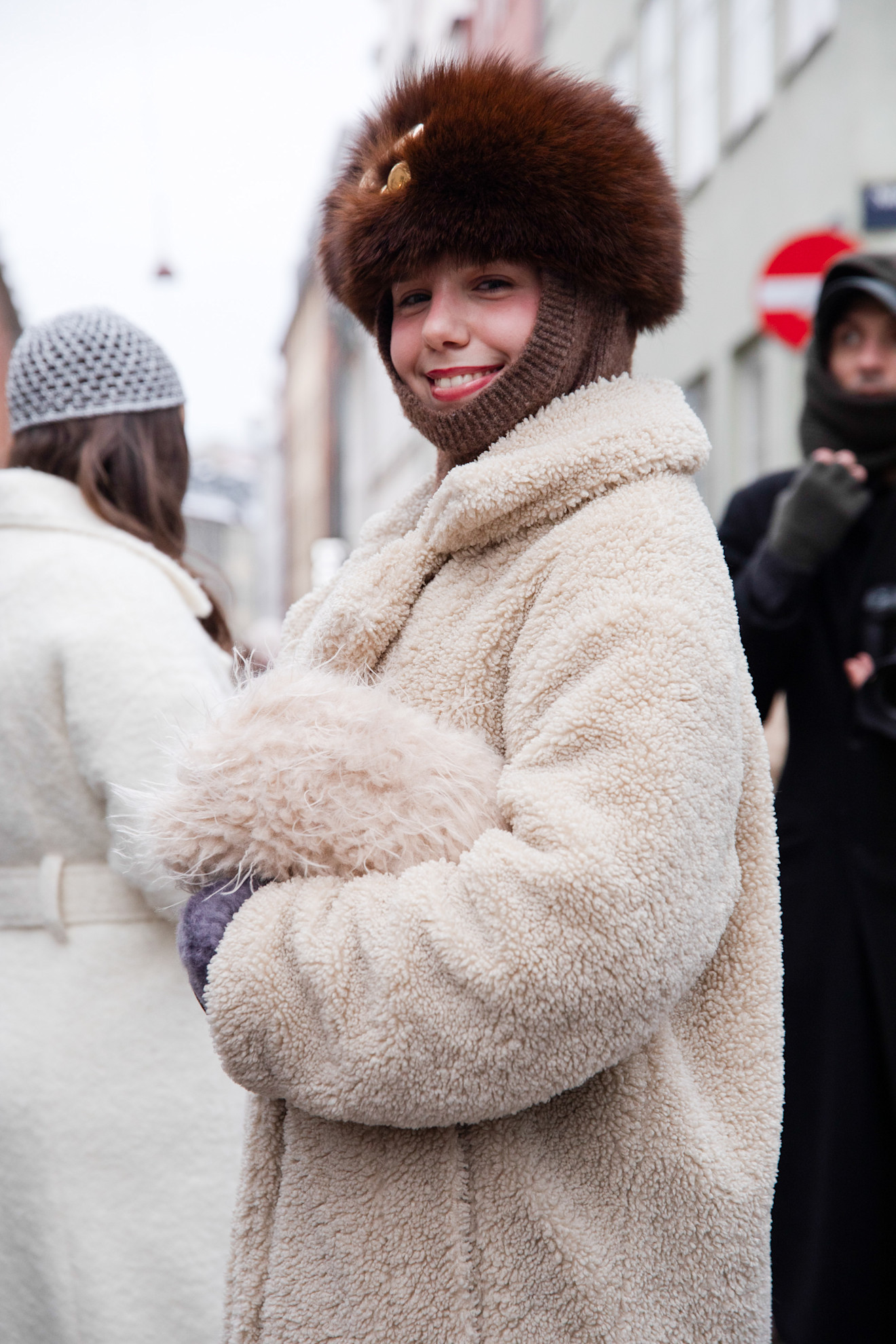 guests at Copenhagen Fashion Week Winter 2026 wearing various faux fur and colorful coats