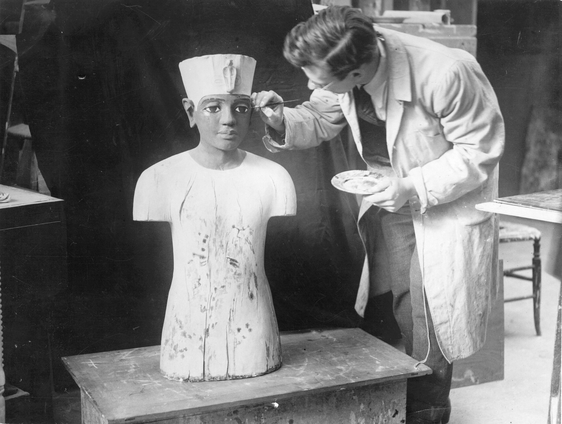 an artist retouches an Egyptian statue