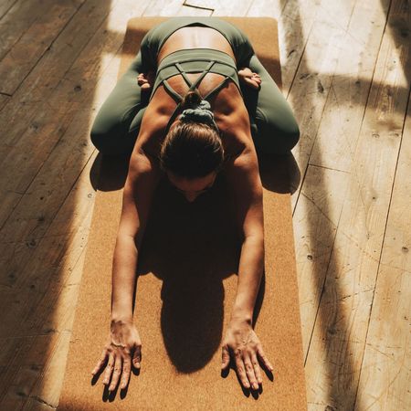 Self-reflection journaling prompts: A woman doing yoga