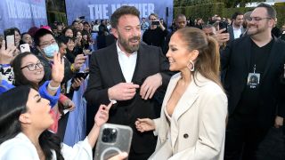 Ben Affleck and Jennifer Lopez laughing with fans at The Mother premiere.