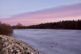 Scenic view of frozen lake against sky during sunset in Ann Arbor,Michigan