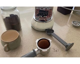 Preparing espresso using ground coffee in glass jar and tamping tool