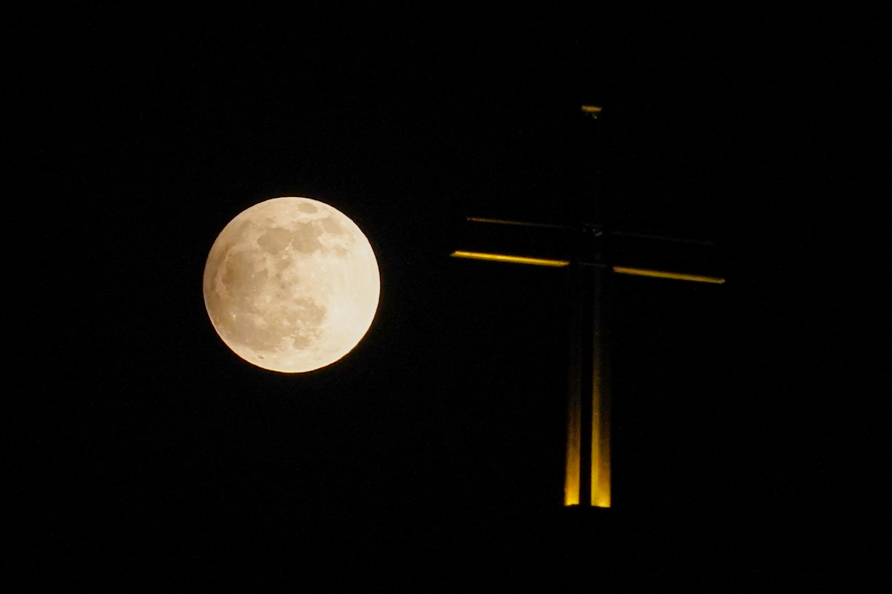 A shadow falls across the full moon