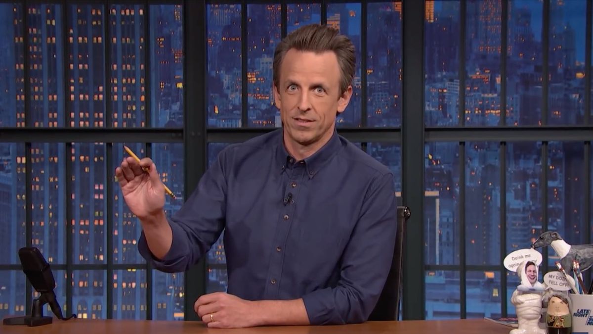 Seth Meyers speaking at his desk on Late Night