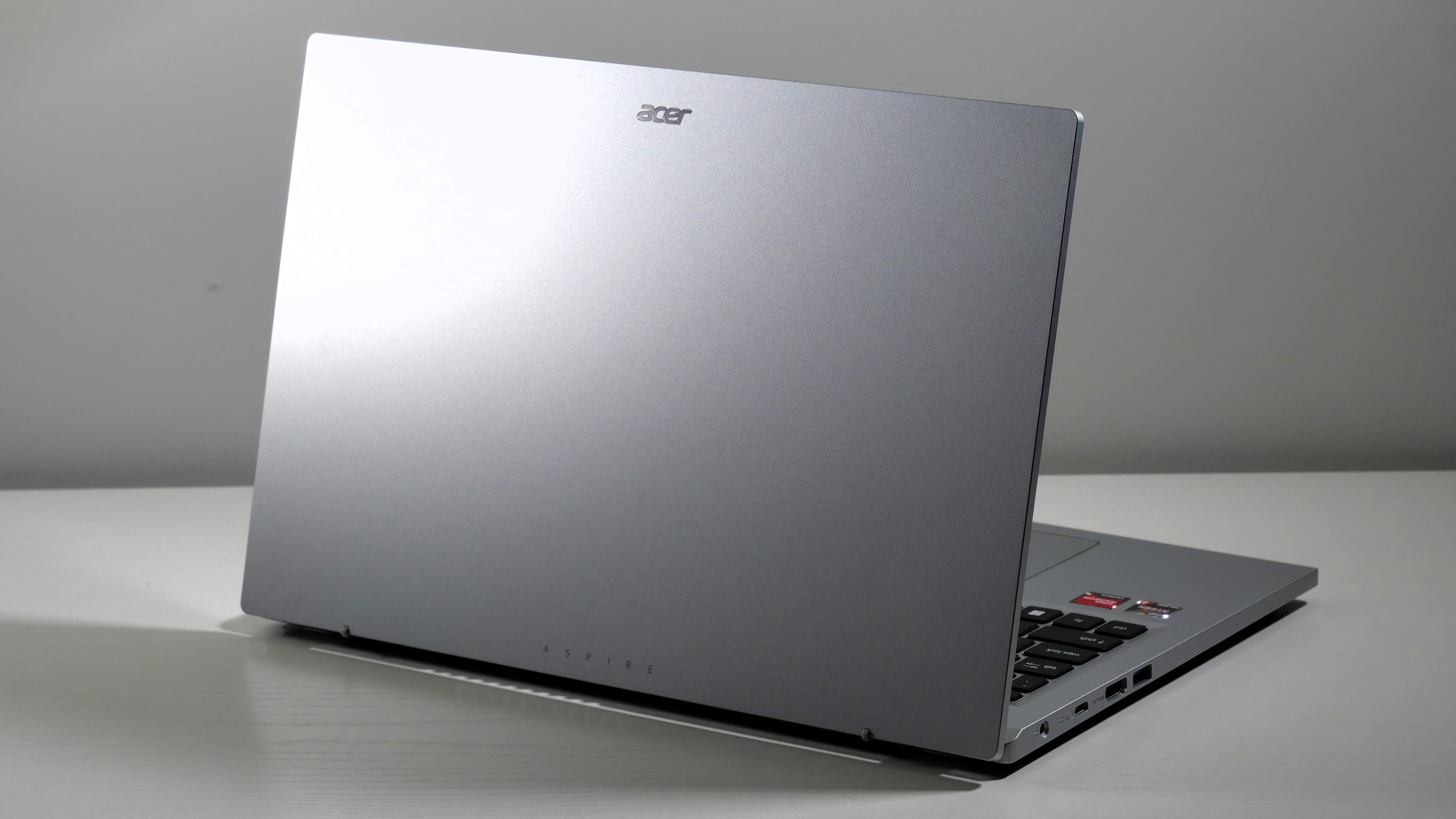 Acer Aspire 3 15 open on a white desk, highlighting the silver lid.