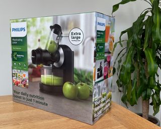 Philips Viva Masticating juicer in box on wooden table