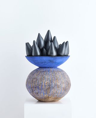 Vase with blue base and spiky black top by Zizipho Poswa