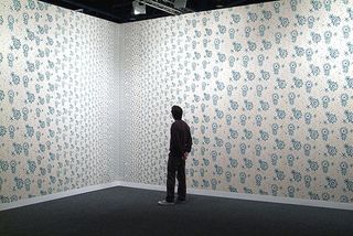 Man in wallpapered room