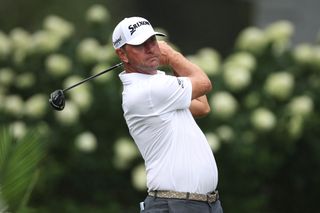 Lucas Glover hits a drive and watches his tee shot