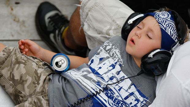  A young boy asleep in his father&amp;#039;s lap