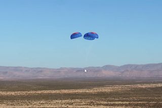 The New Shepard 2.0 crew capsule parachutes back to Earth during its first test flight, on Dec. 12, 2017.
