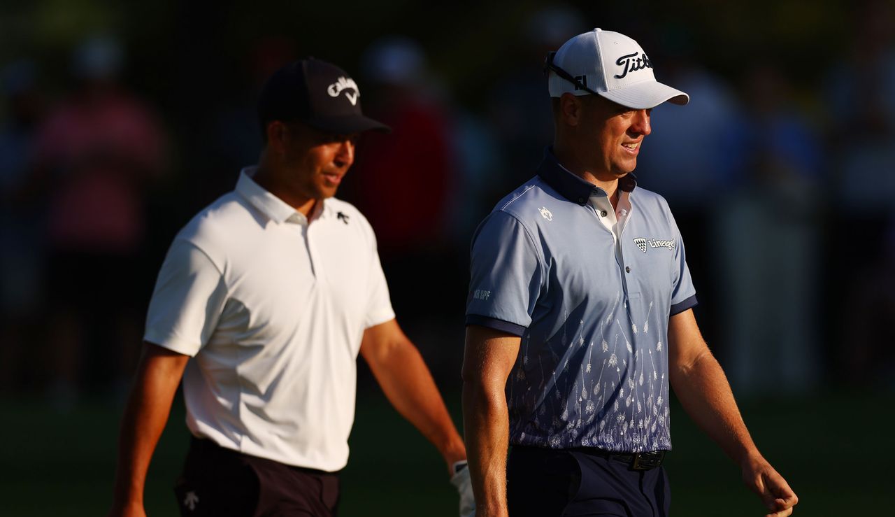 Xander Schauffele and Justin Thomas walk up the 10th fairway