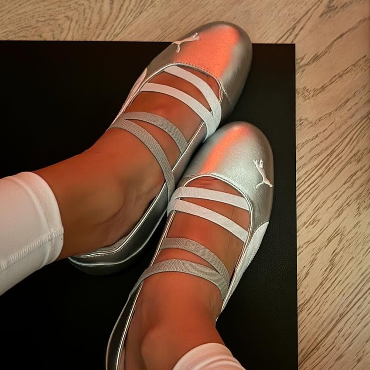 Woman wearing metallic Puma Speedcat Ballet sneaker.