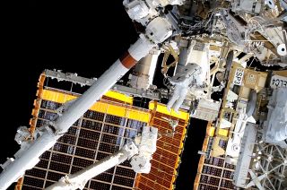 nasa astronaut conducts a spacewalk outside the international space station