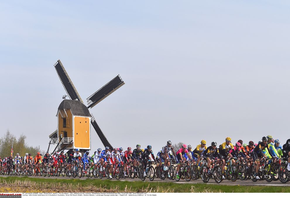The peloton passes one of the many windmills on the parcours