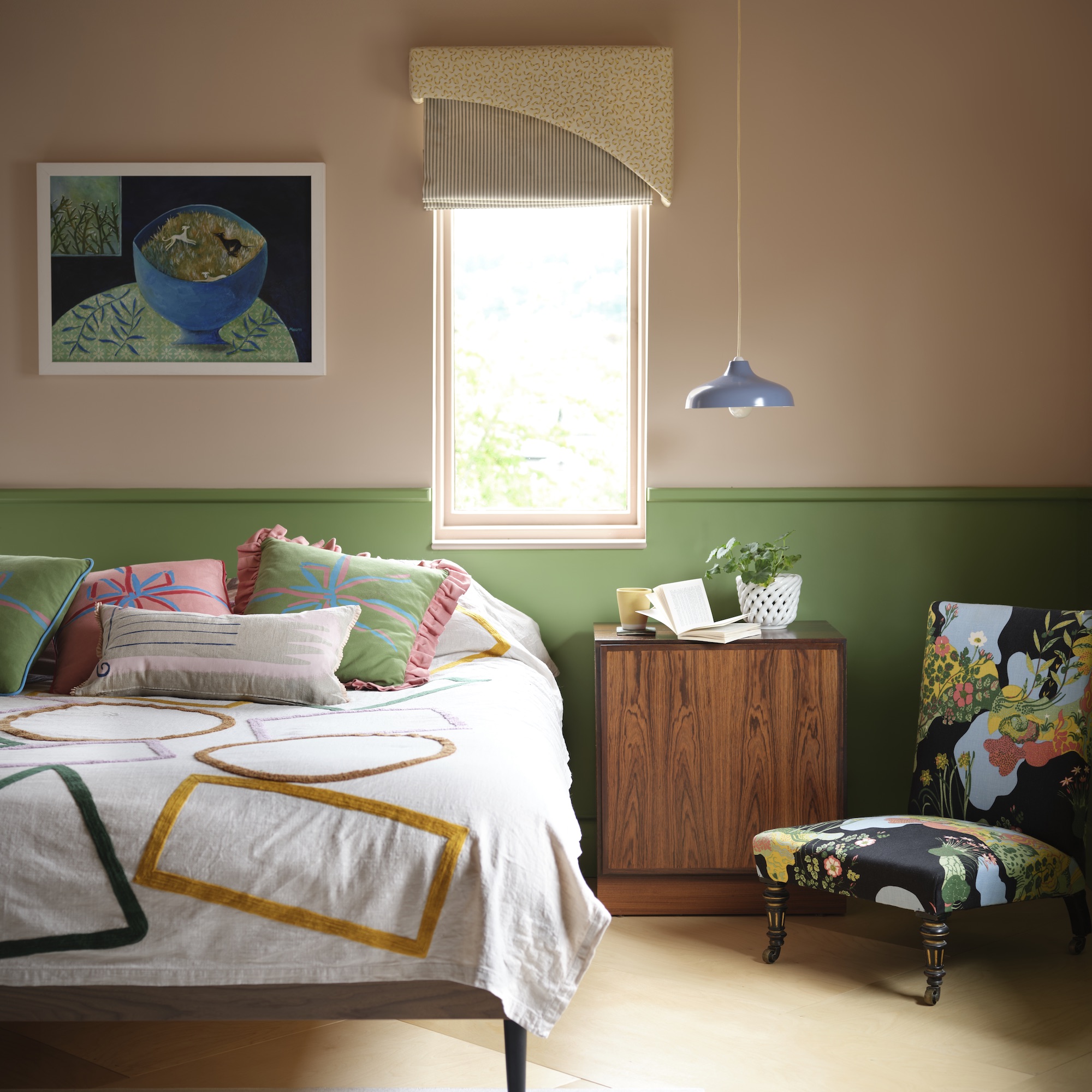 bedroom with green and pink walls and bed and wooden bedside table and chair