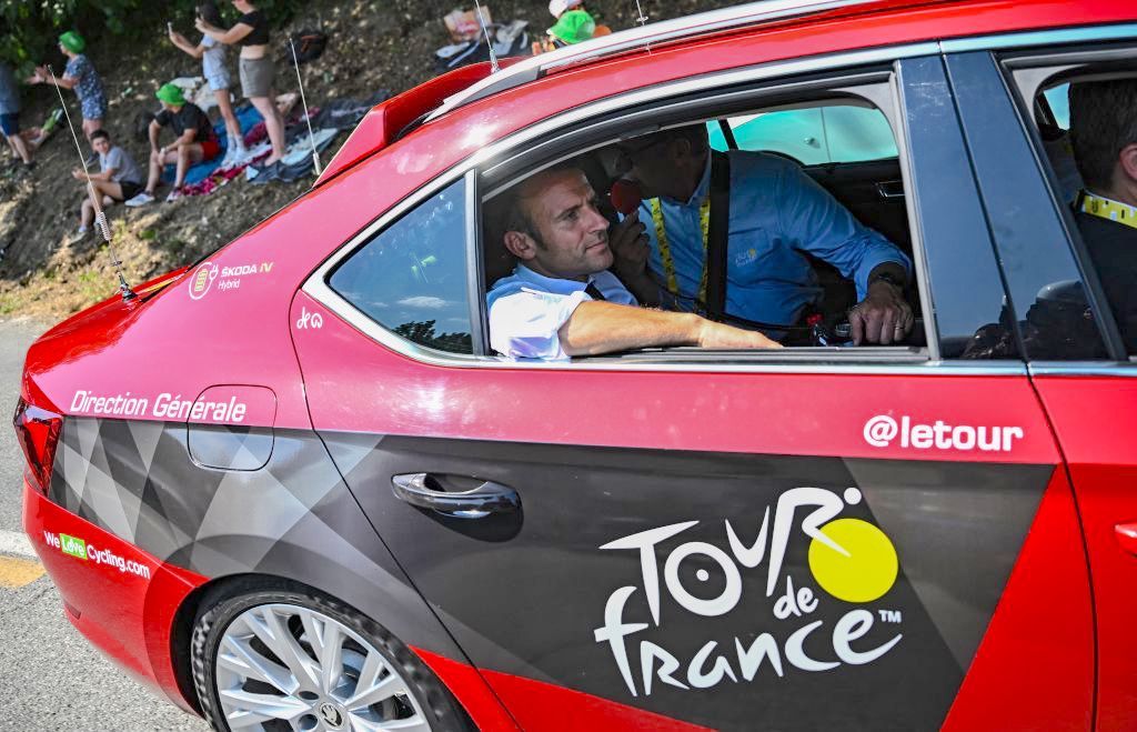 French President Emmanuel Macron looks on in a car during the 18th stage of the 109th edition of the Tour de France cycling race, 143,2 km between Lourdes and Hautacam in the Pyrenees mountains in southwestern France, on July 21, 2022. (Photo by Anne-Christine POUJOULAT / POOL / AFP) (Photo by ANNE-CHRISTINE POUJOULAT/POOL/AFP via Getty Images)