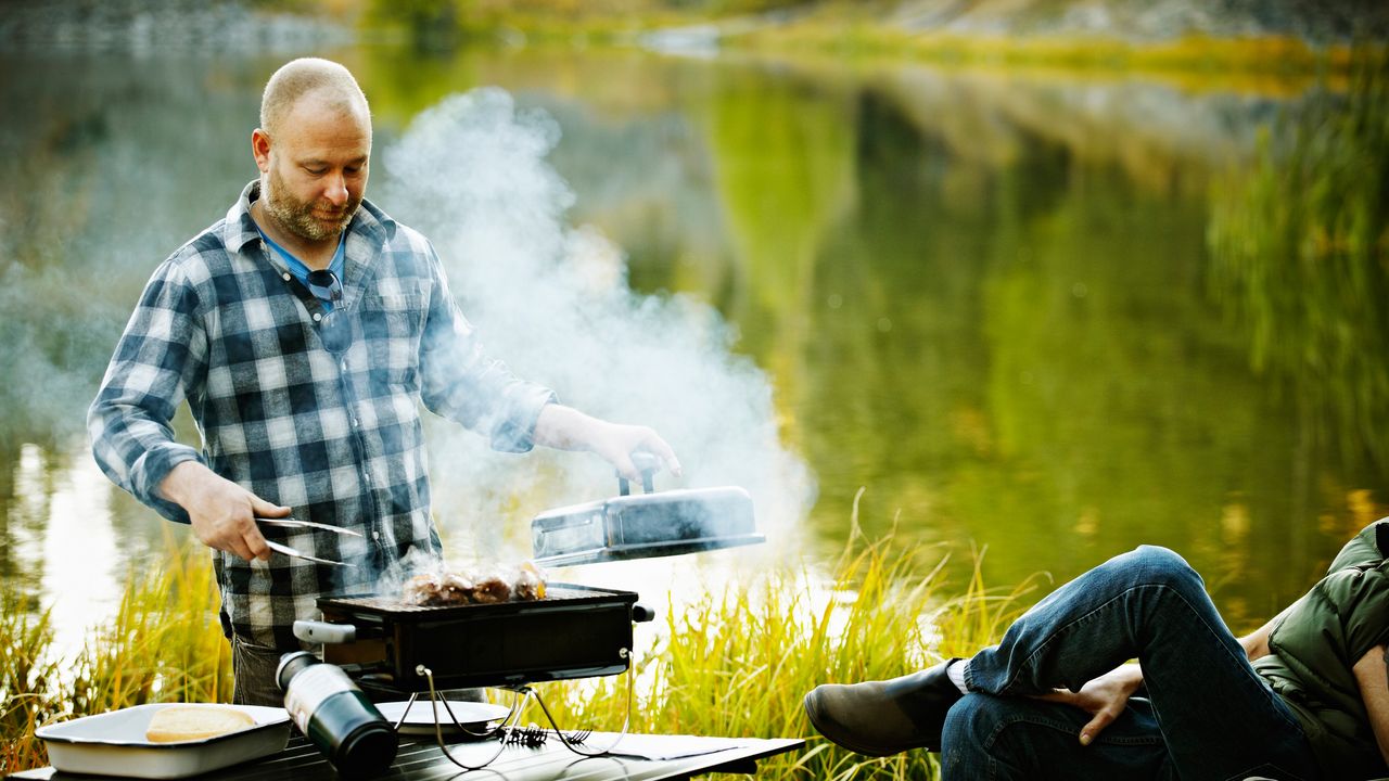 Man barbecuing big joints of meat