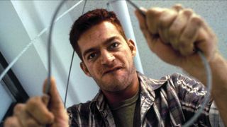 Harry Connick Jr. holding a wire in Copycat