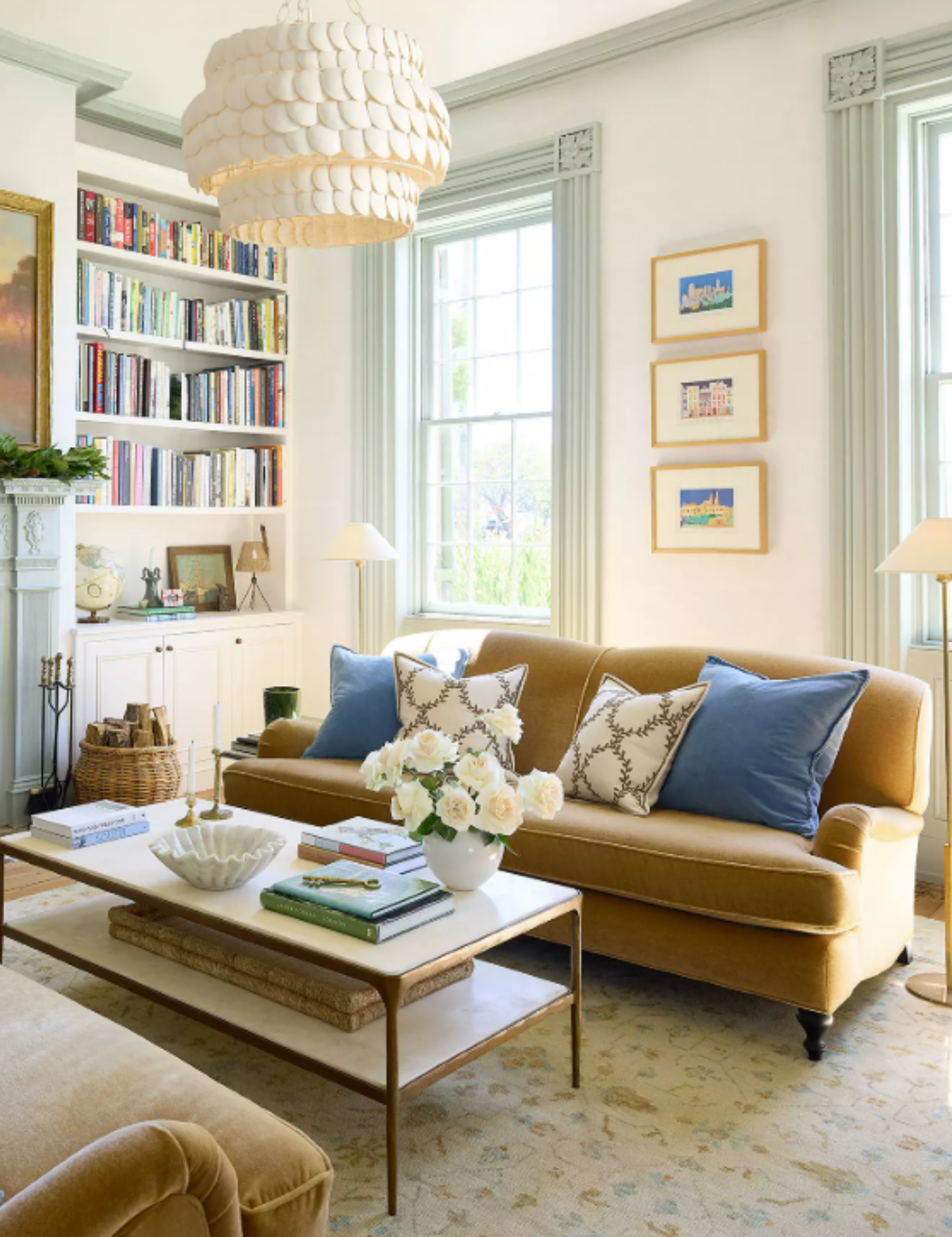 coastal living room with pale blue fireplace and camel velvet couches