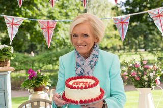 Mary Berry holding a cake