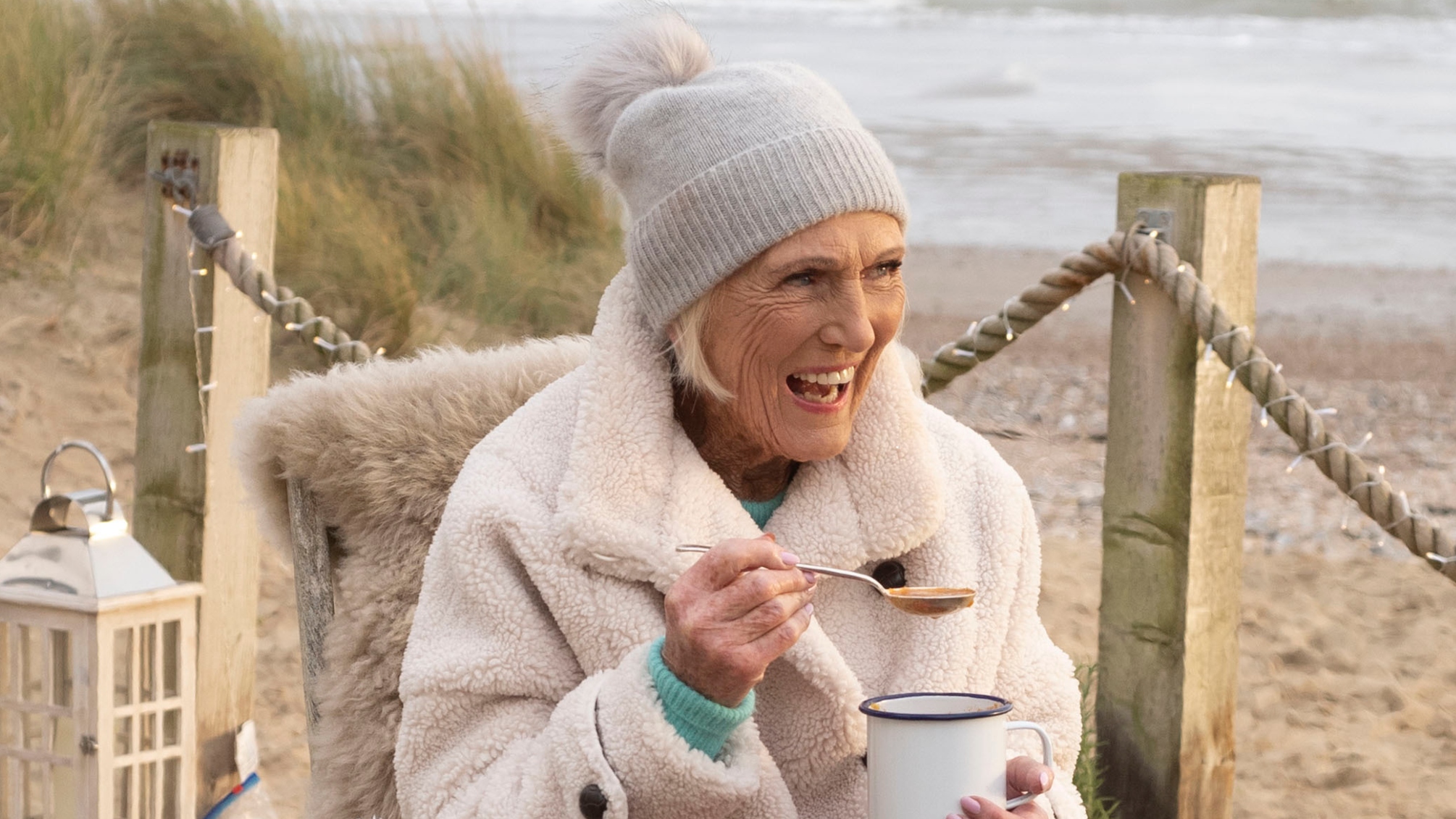 Mary Berry smiles as she eats soup at Camber Sands beach