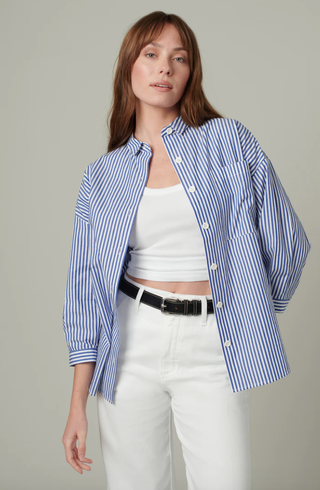 Woman standing in buttoned shirt