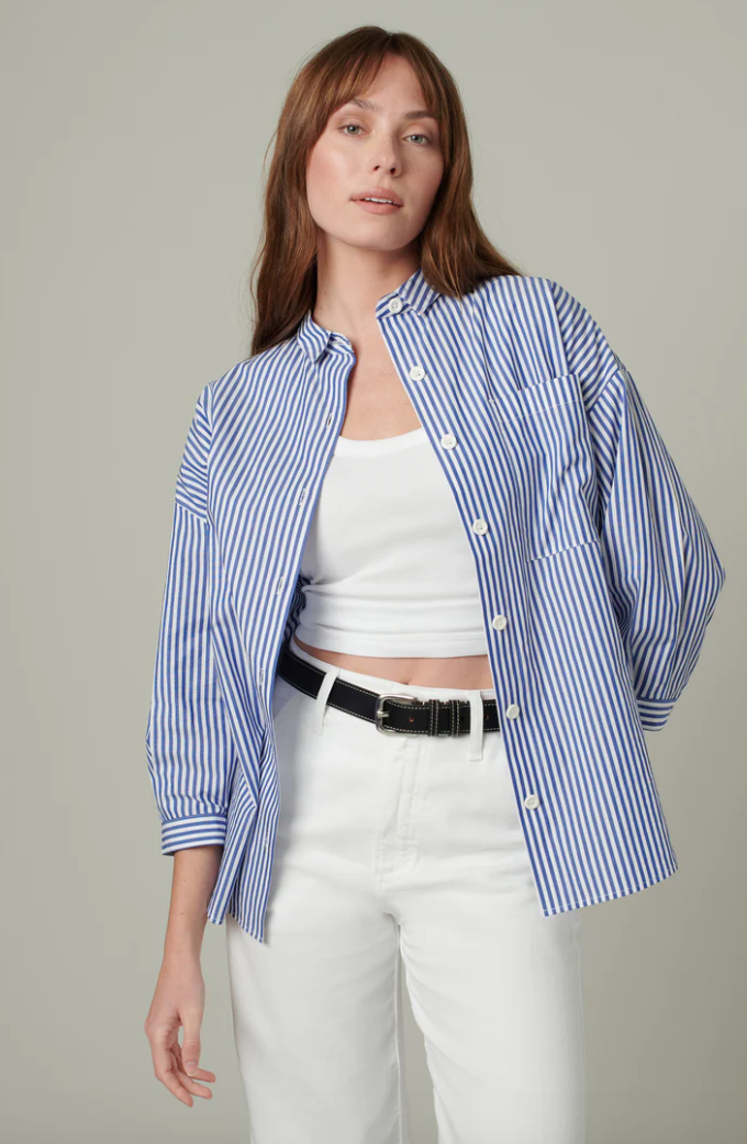 Woman standing in a button down shirt