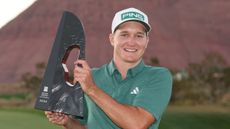 Matt McCarty poses with the Black Desert Championship trophy after winning in 2024