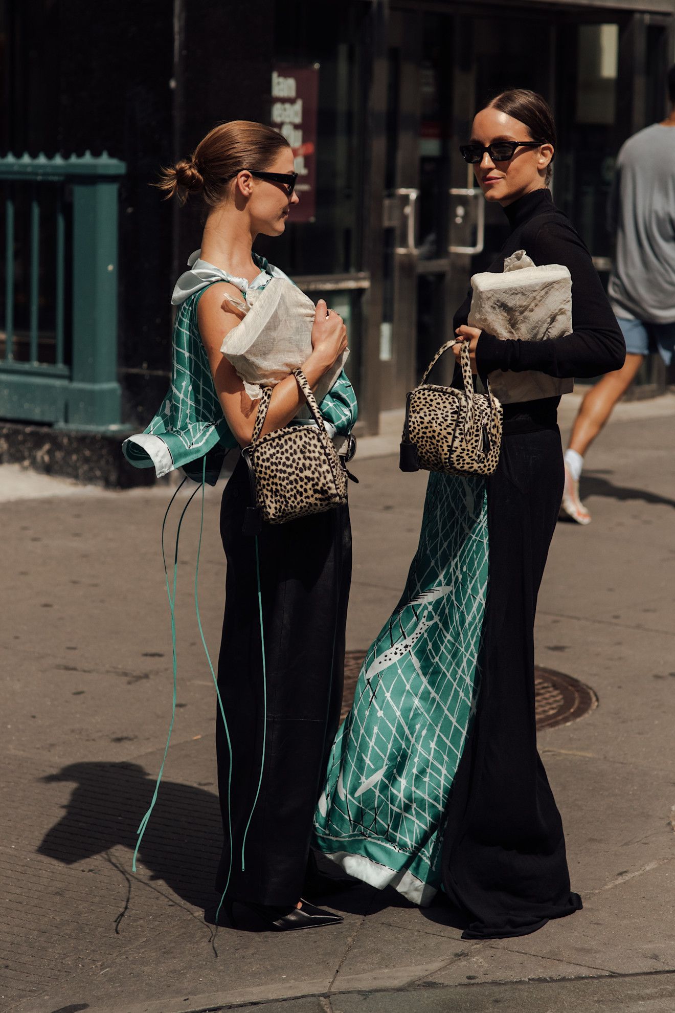 Guests outside of Altuzarra wearing the green scarf print from F/W 26.
