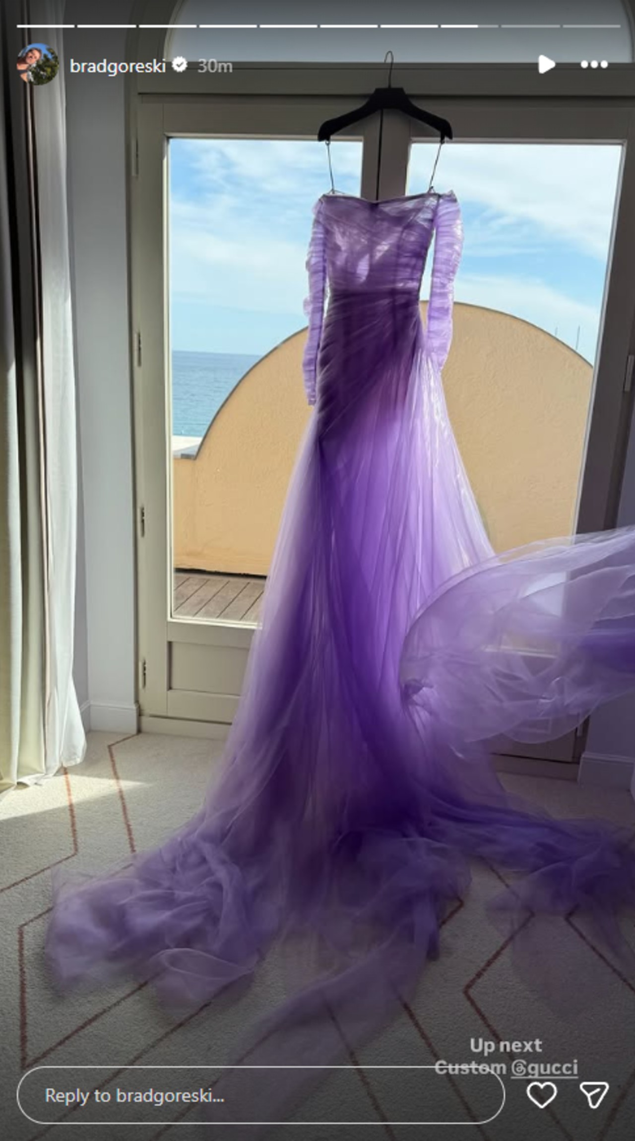Demi Moore's lavender dress hanging on a hanger.