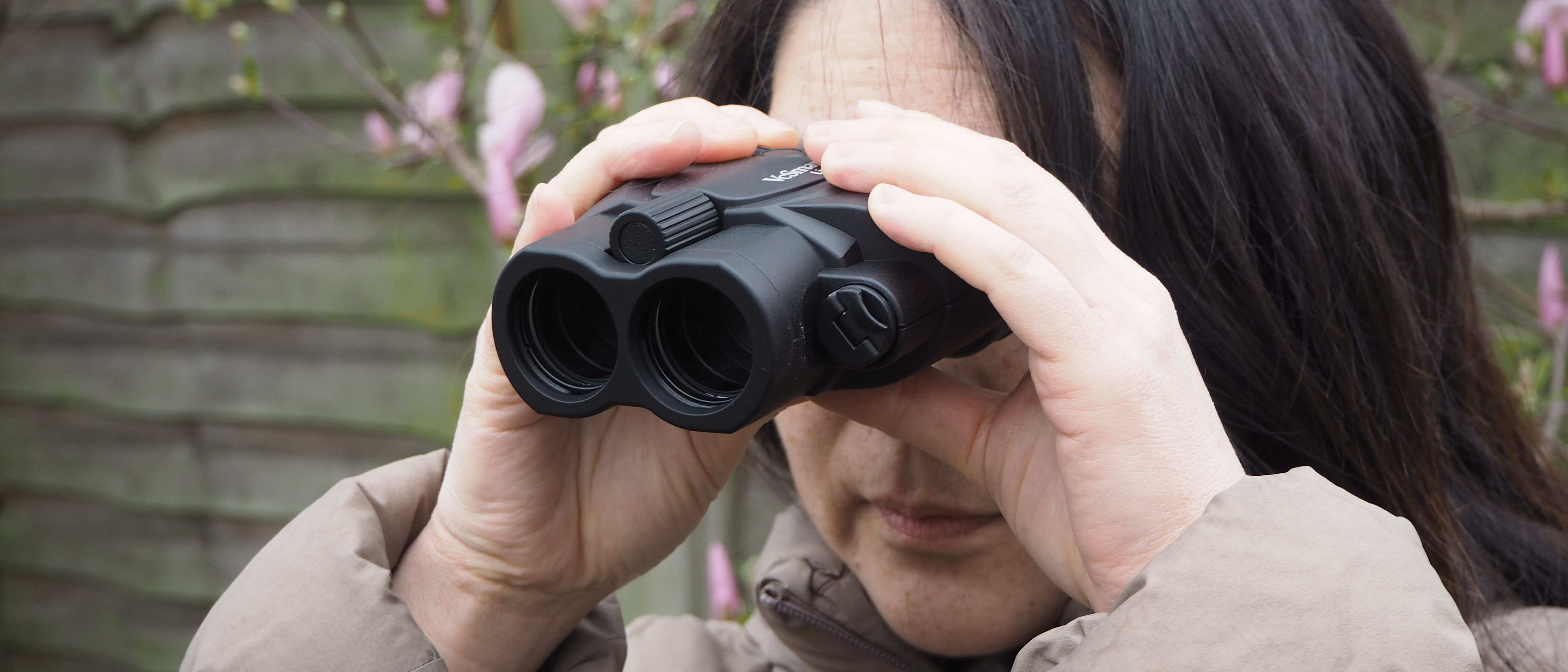 Kenko Vc Smart 14x30 Light binoculars handheld with a person looking through them