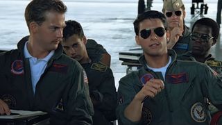 Tom Cruise chills out in his desk in Top Gun