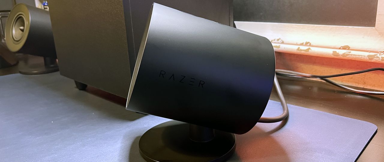 Sideview of Razer Nommo V2 speaker on desk.