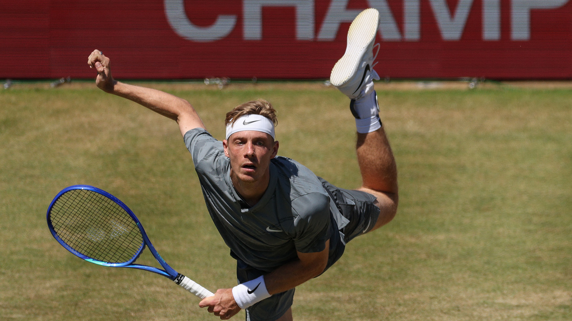 Canada's Denis Shapovalov serves against Australia's Alex de Minaur during their tennis match in London, United Kingdom