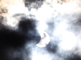 This photo of a partial solar eclipse view through clouds on April 29, 2014 was captured by skywatcher Roxanne Whitehead from her backyard in Port Augusta in South Australia during the annular solar eclipse of 2014.