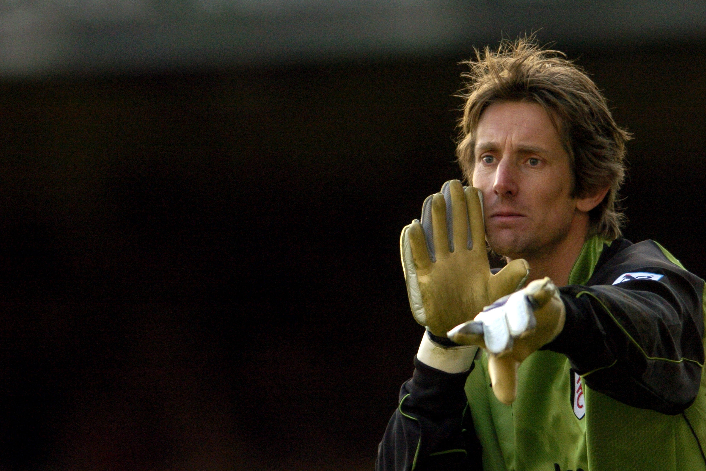 Fulham goalkeeper Edwin van der Sar gives orders to his defenders during a match, 2004