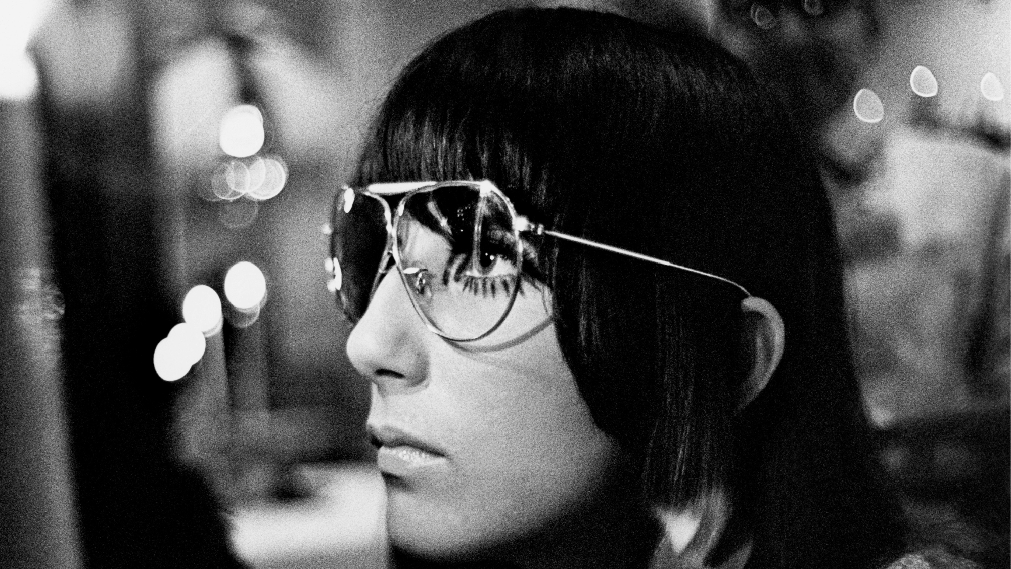 Headshot of Cher wearing aviator sunglasses in 1967.