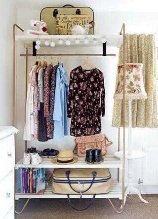 Neutral bedroom with a freestanding clothes rail in the corner to support Trinny's clothes rail styling tip