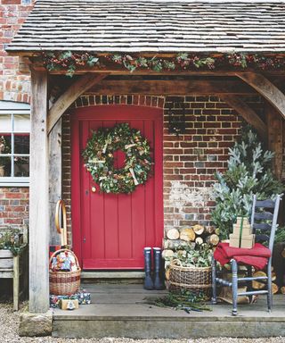 Christmas porch decor ideas with a red front door and large green wreath