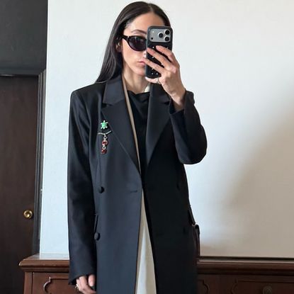 Alexis Badiyi wearing a long blazer