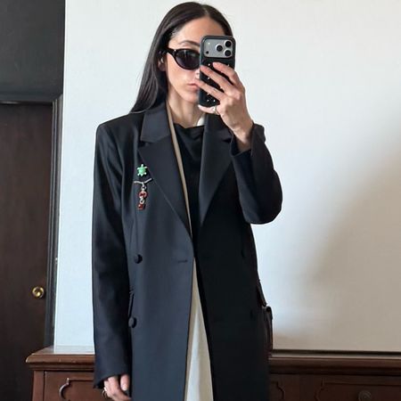 Alexis Badiyi wearing a long blazer 