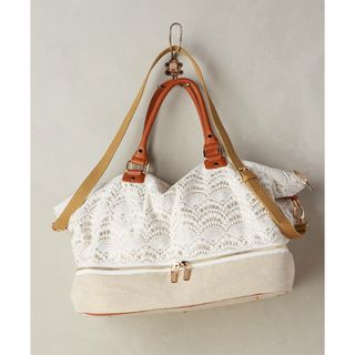 Anthropologie Fanned Lace Weekender bag with white crocheted lace exterior with faux leather trimming