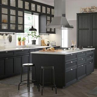 black and white kitchen with glass cabinets and chrome hob