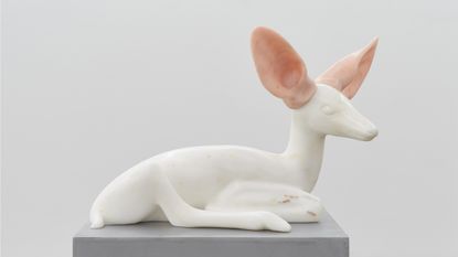 sculpture of a fawn made from stone.