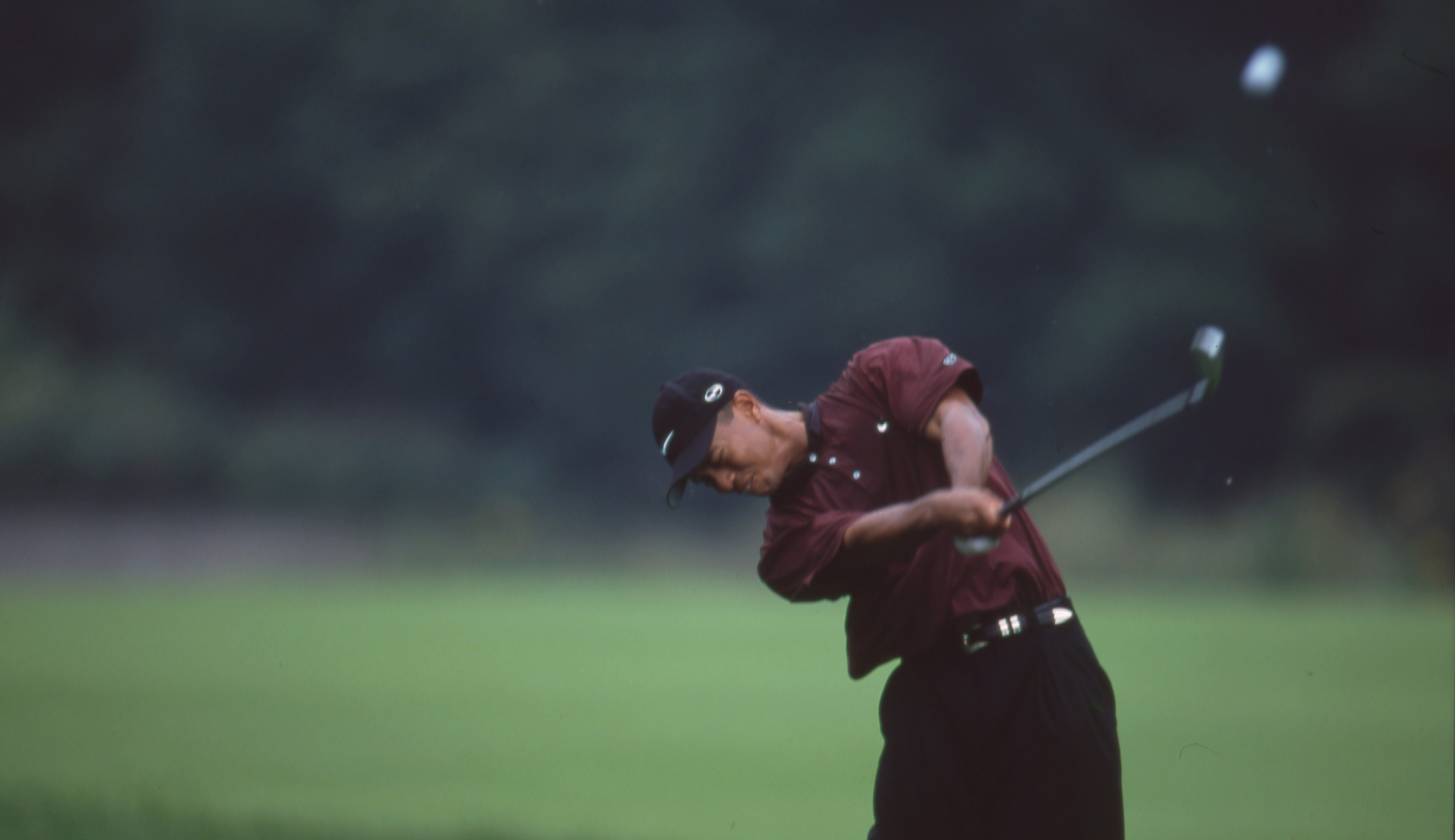 Tiger Woods hits an iron shot out of the bunker