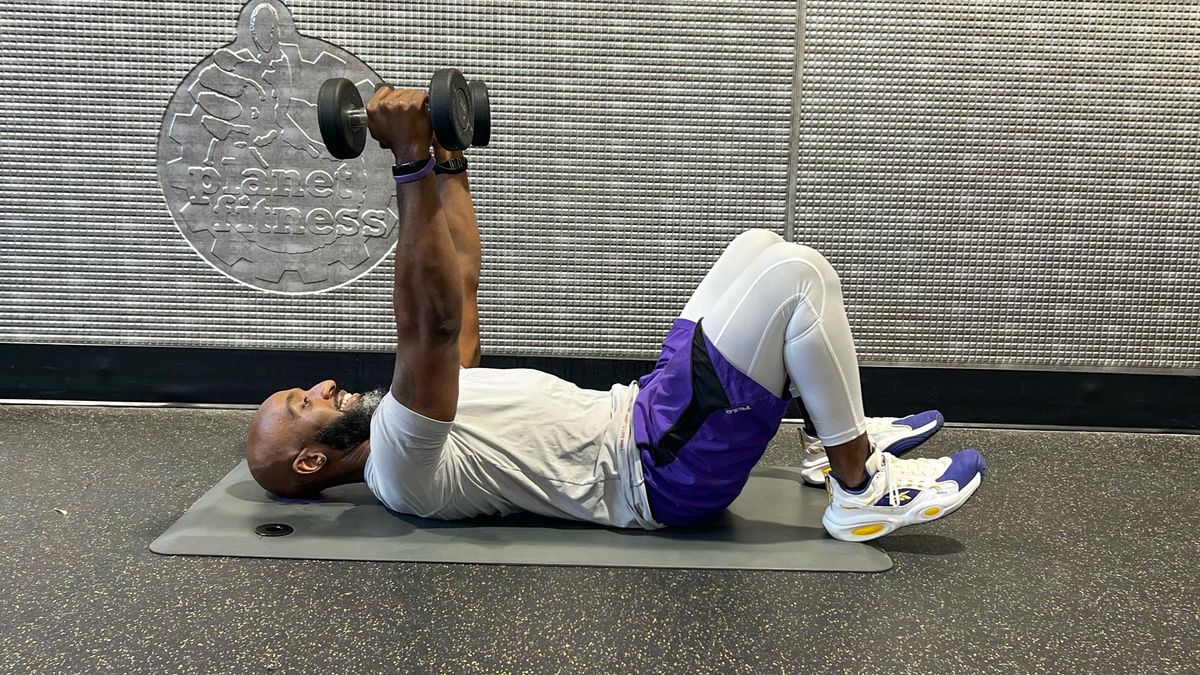 Teddy Savage doing a dumbbell floor chest press to triceps skull crusher