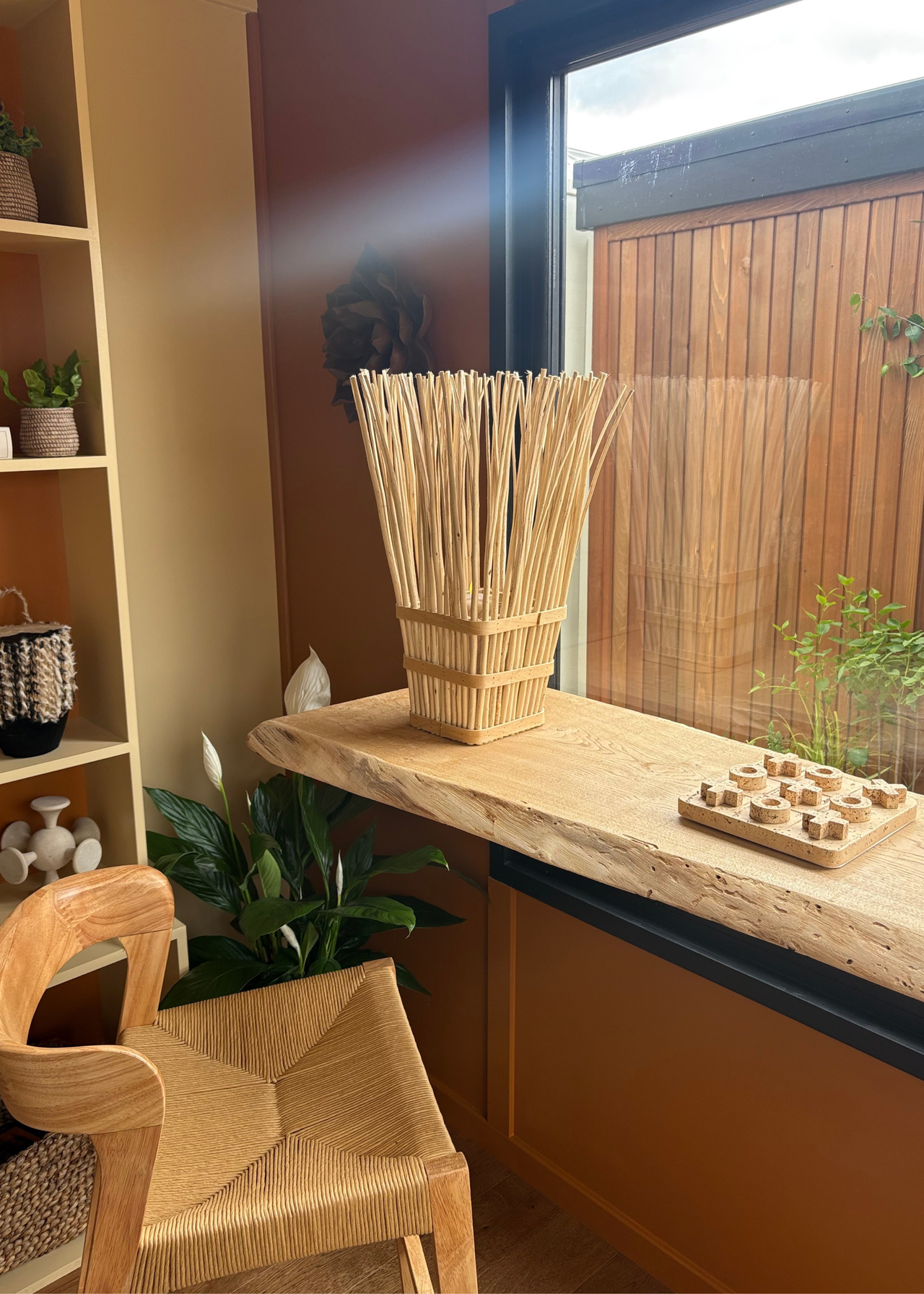 An outdoor shed with a game space featuring a minimalist Xs and Os set at the Chelsea Flower Show 2026